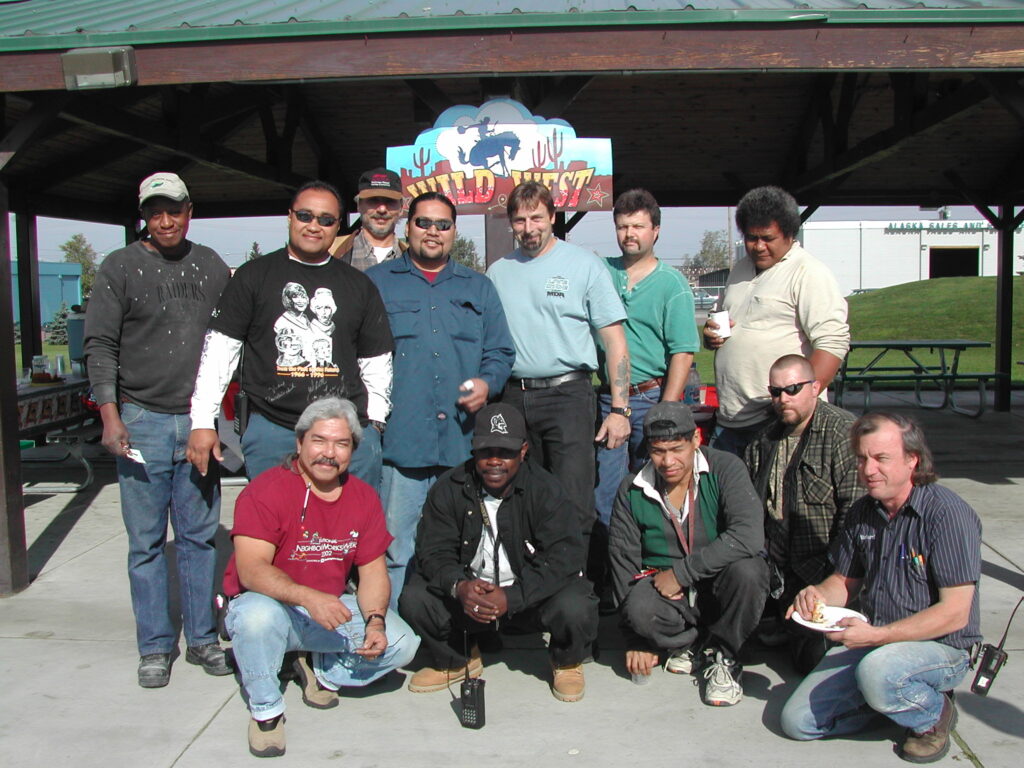 Group photo of our maintenance team at a Wild West themed party in 2003