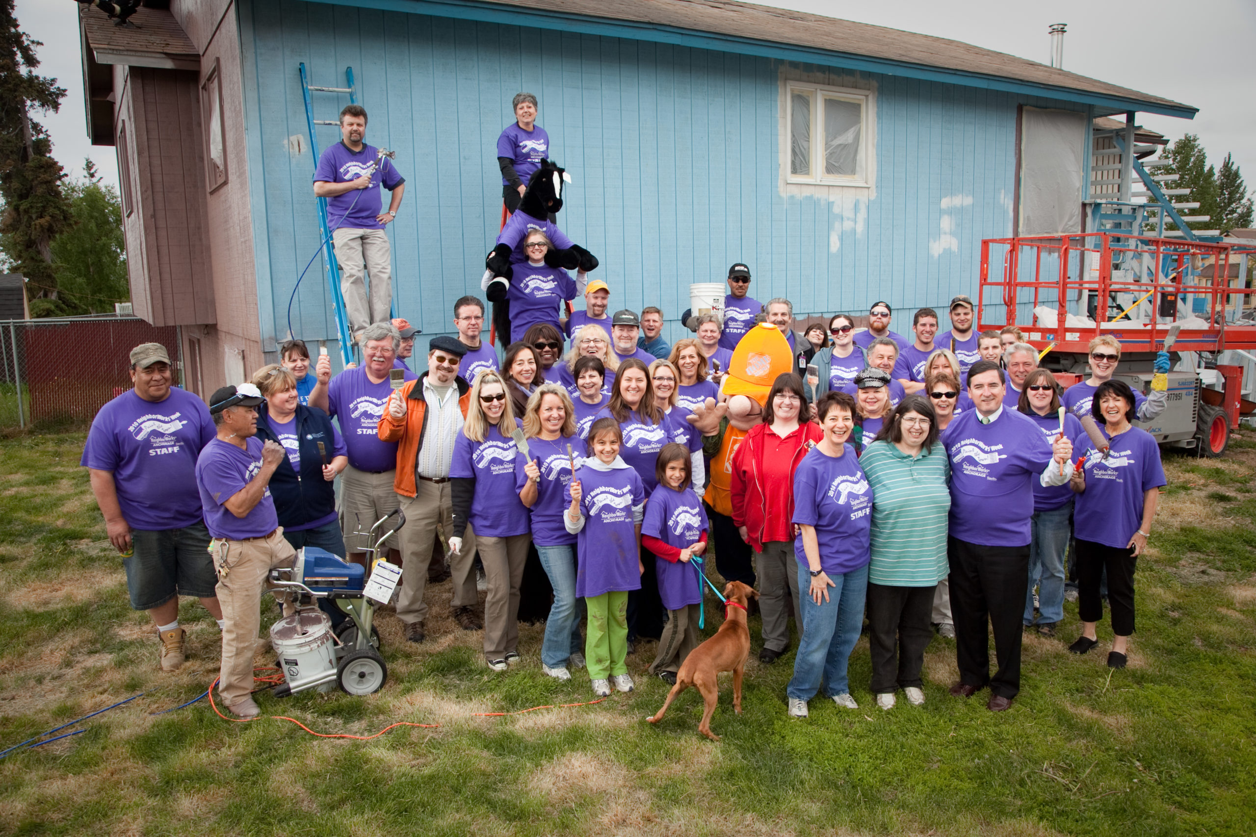 Home owner, Sharron Webb, is flanked by Neighborworks Anchorage Executive Director, Debe Maloney and Mayor Dan Sulivan, with Paint the Town volunteers from Dyanmic Realty at 1750 Thuja.