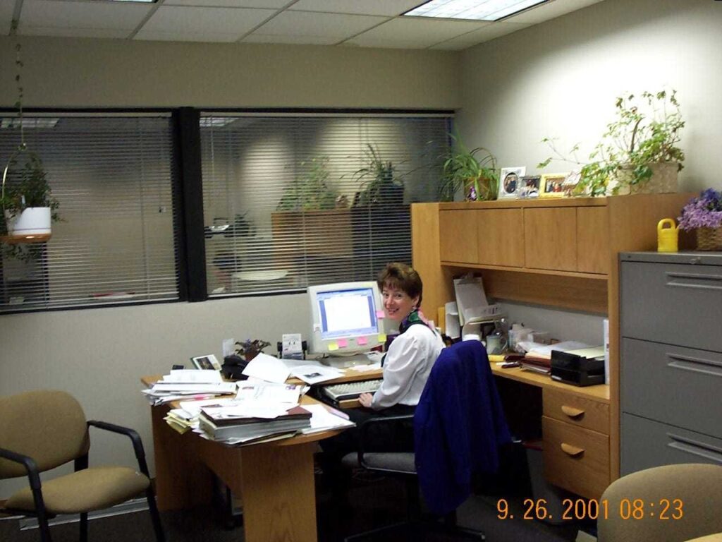 Debe Mahoney at her desk around 2001
